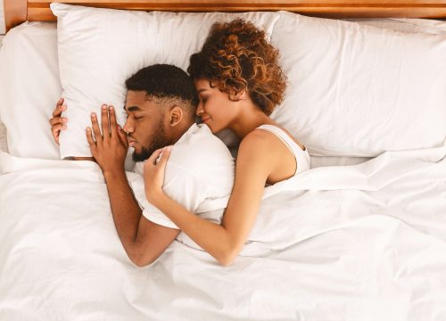 Couple sleeping peacefully in bed after NightLase